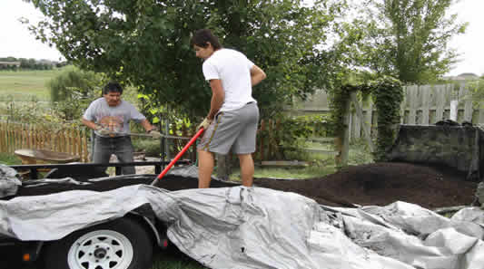 Tosh and Josh shovel mulch